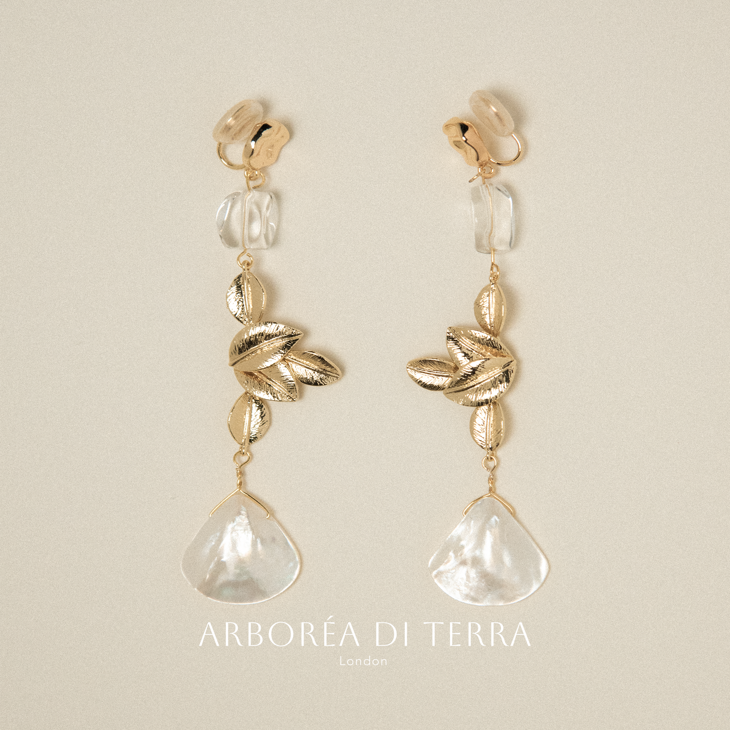 Clip on earrings with natual shell and plated gold leaves